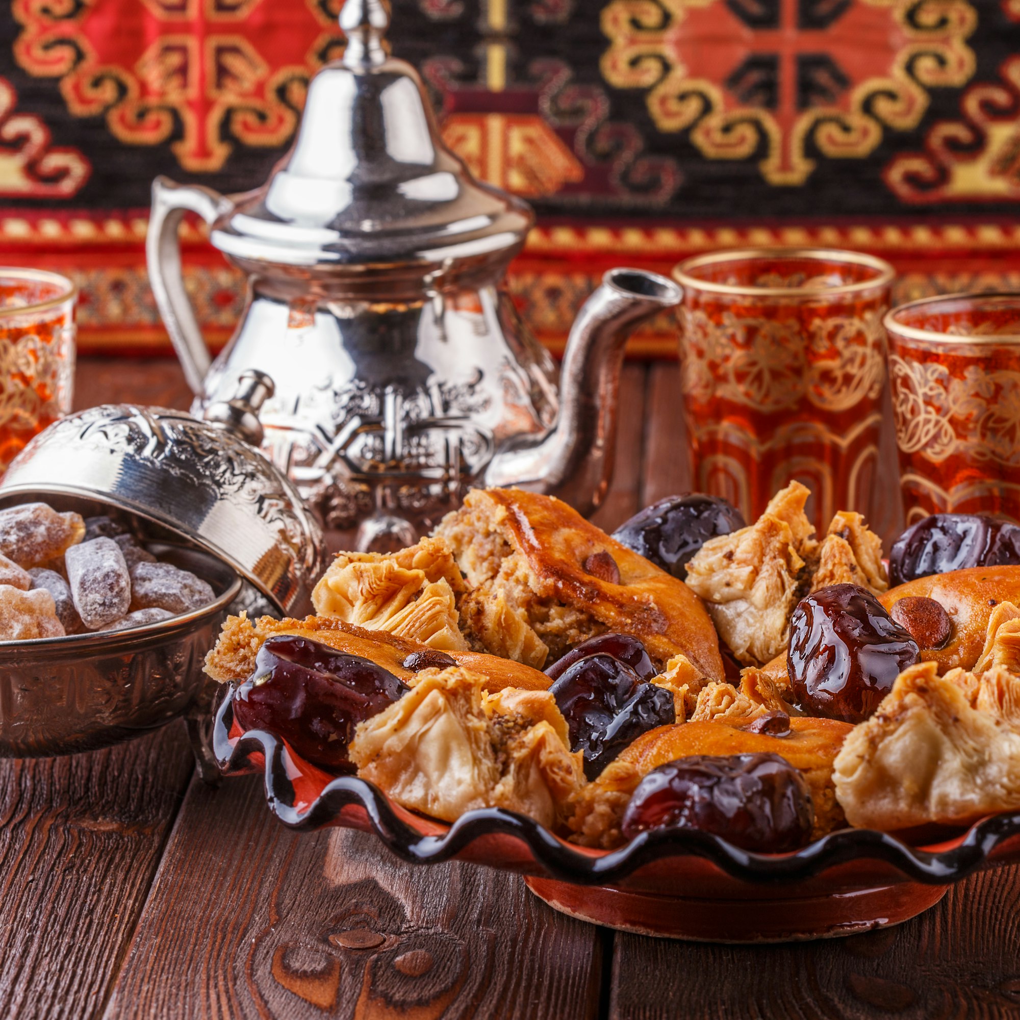 Moroccan mint tea in the traditional glasses with sweets.